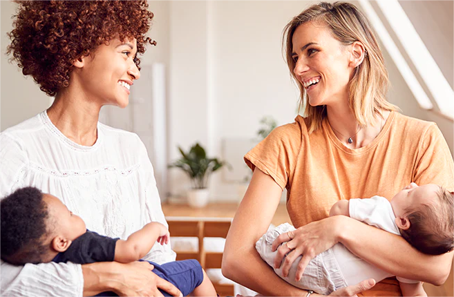 Two moms holding their babies