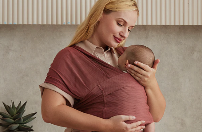 A mom is wearing her baby with a baby wrap
