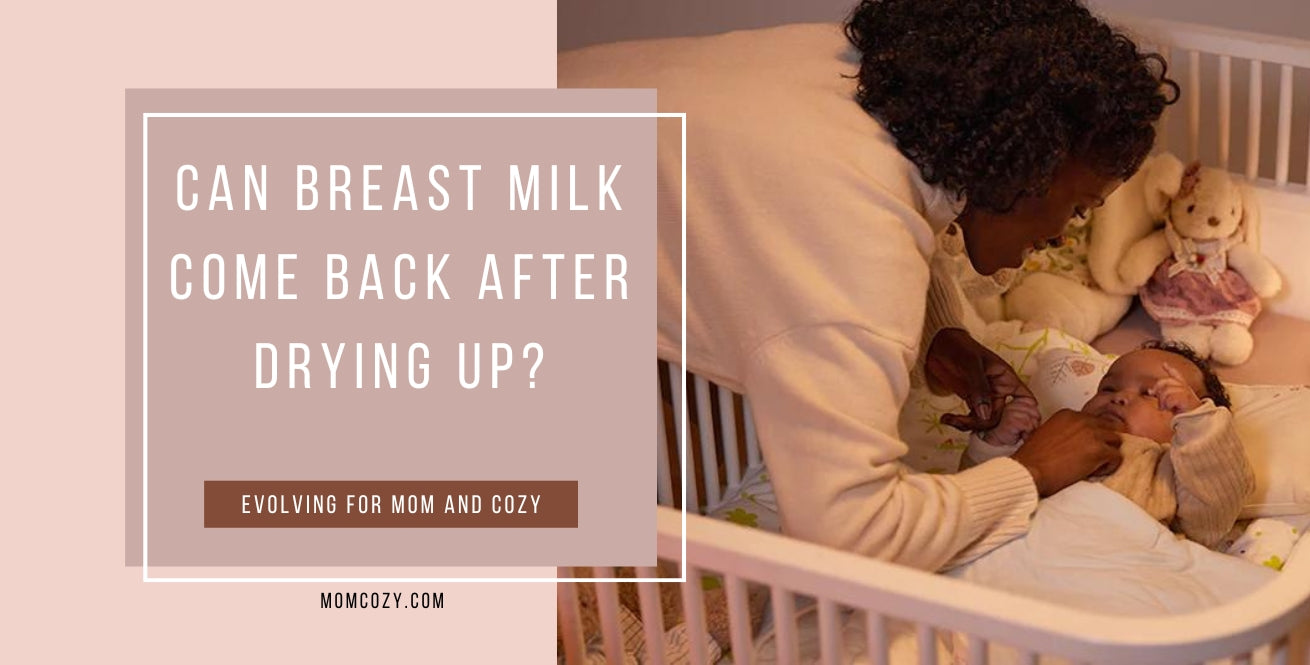 A mother holds her baby in a crib