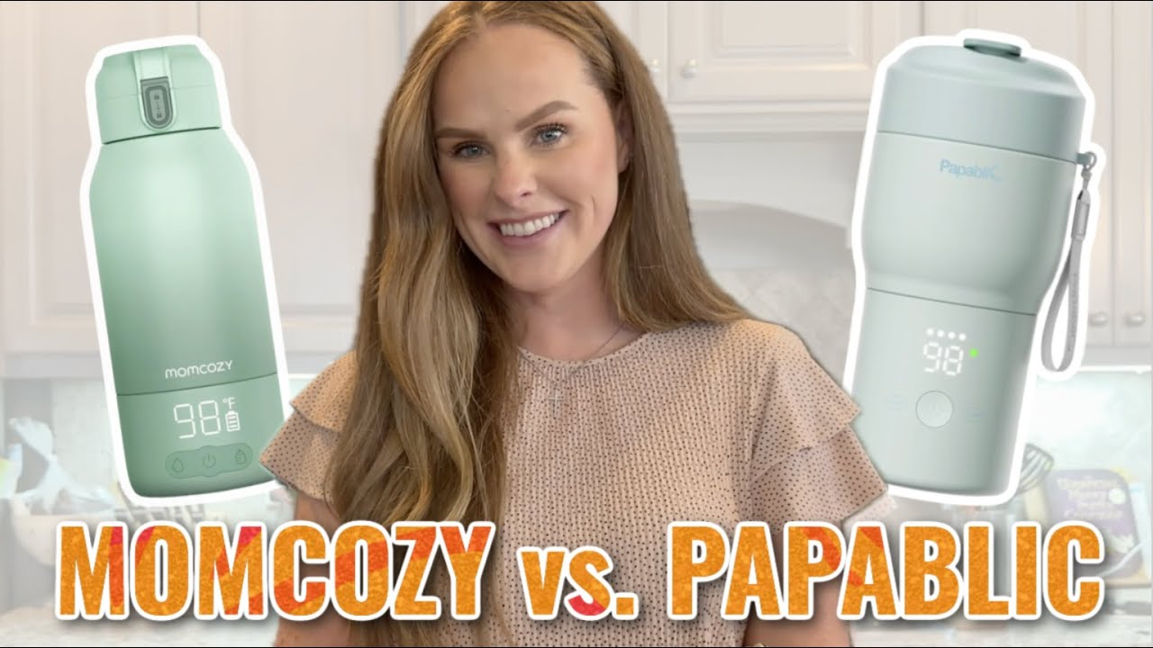 A woman smiles between a green Momcozy bottle warmer on the left and a white Papablic bottle warmer on the right, with large text at the bottom reading "MOMCOZY vs. PAPABLIC"