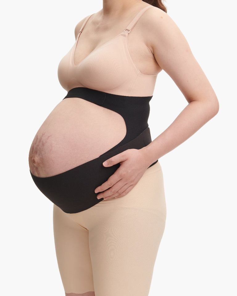 Translation missing: fr.Black Momcozy BumpEase maternity band on pregnant person, showing ergonomic support fit