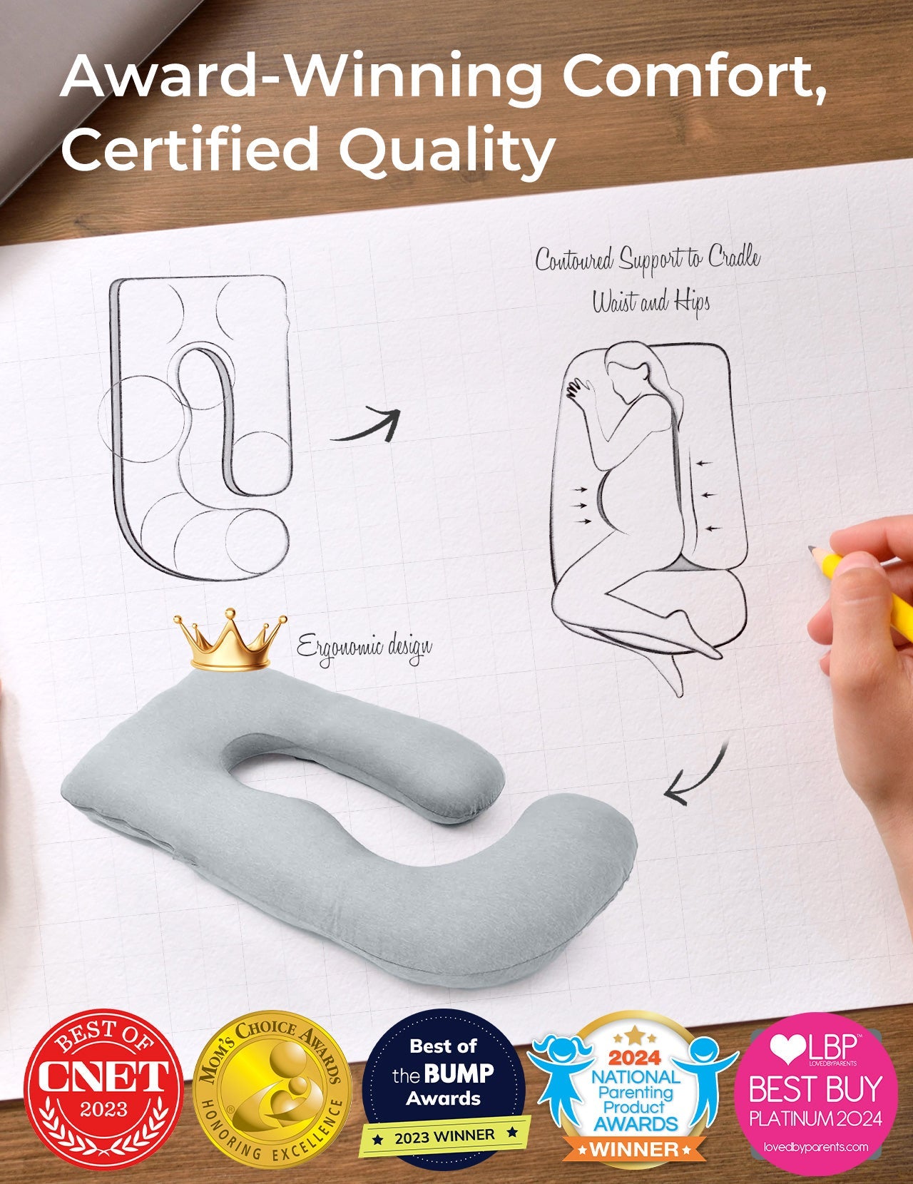 Light grey U-shaped maternity pillow, ergonomic design, supports pregnant women. Award-winning comfort.
